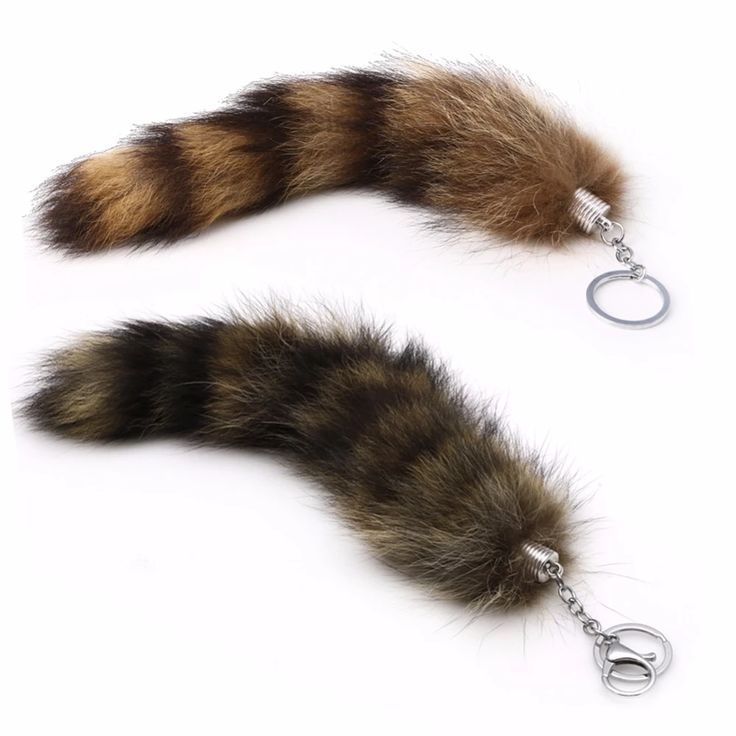 two furry animal tail key chains on a white background