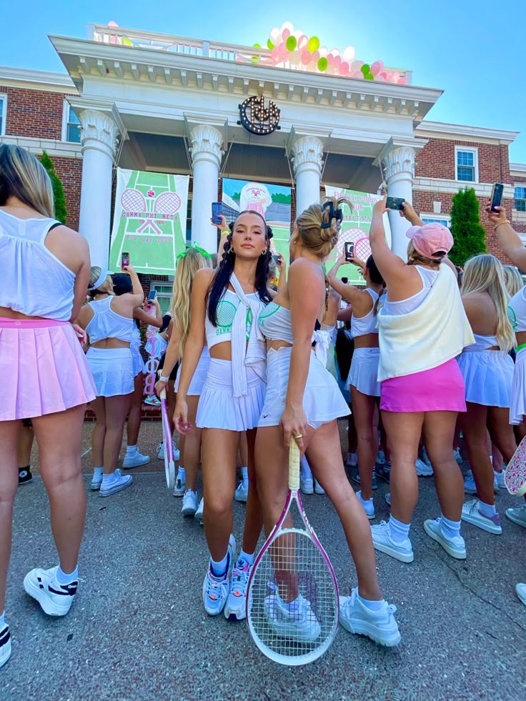 the girls are all dressed up and holding tennis racquets in their hands