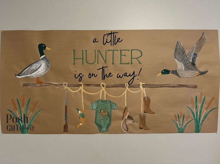 there is a sign with ducks on it that says a little hunter is on the way