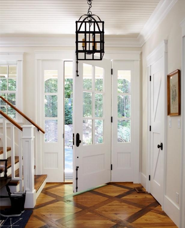 a foyer with wooden floors and white doors