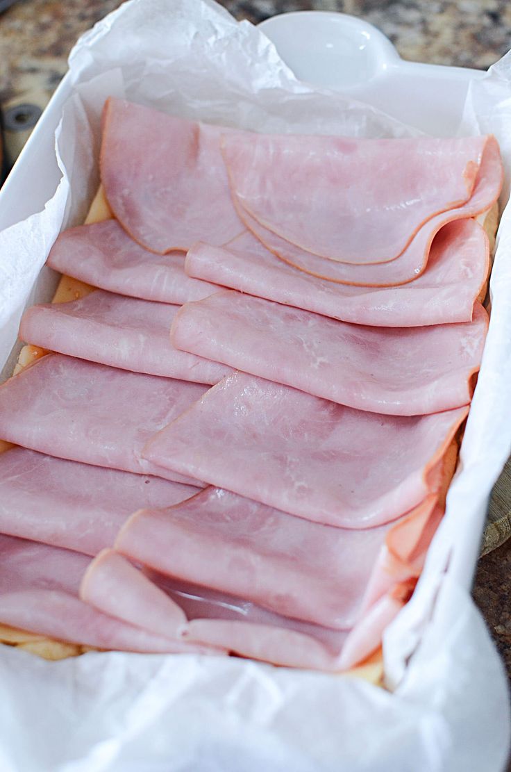 ham slices in a white container on a counter