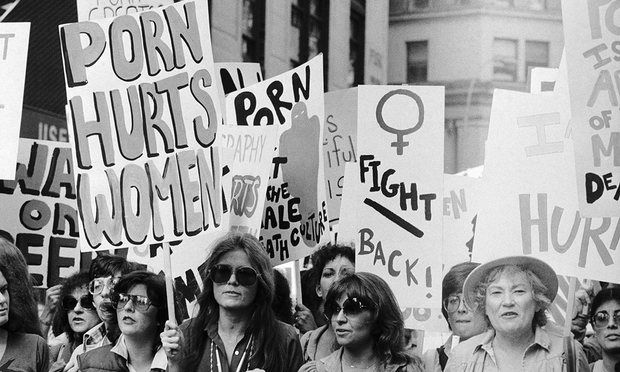 a group of women holding signs in the street