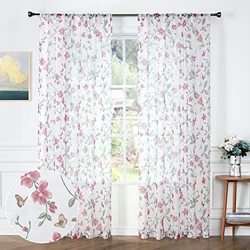 the curtains in this room are decorated with flowers and butterflies, while the window curtain is closed