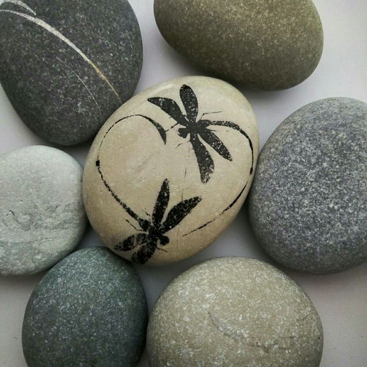 several rocks with designs on them sitting next to each other in the middle of a circle