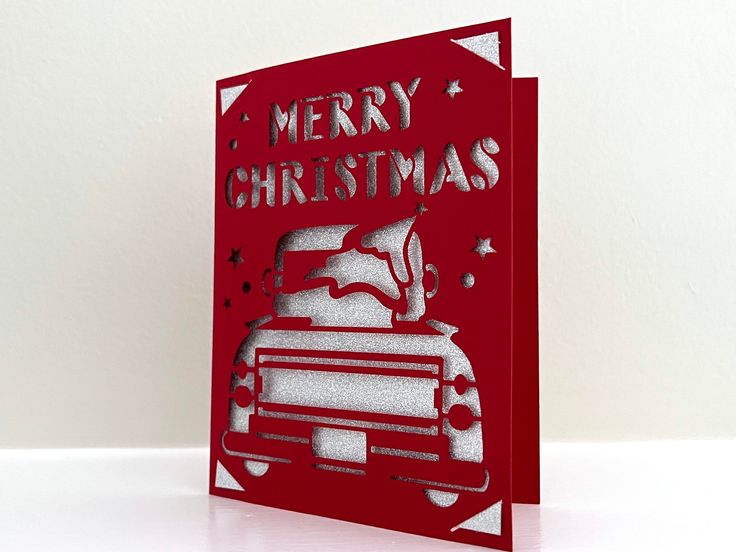 a red christmas card with a truck on it