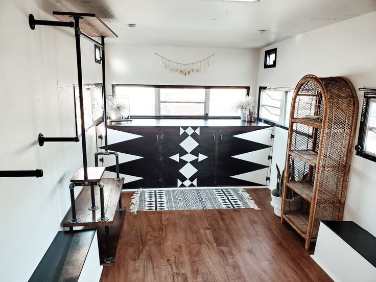 the inside of a house with wood floors and black and white decor on the walls