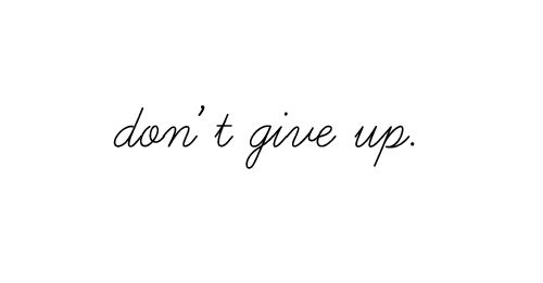 the words don't give up written in black ink