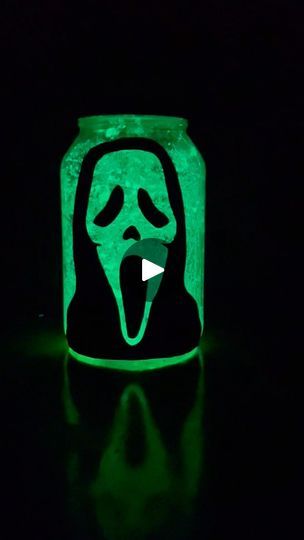 a lit up jar with a ghost face on it