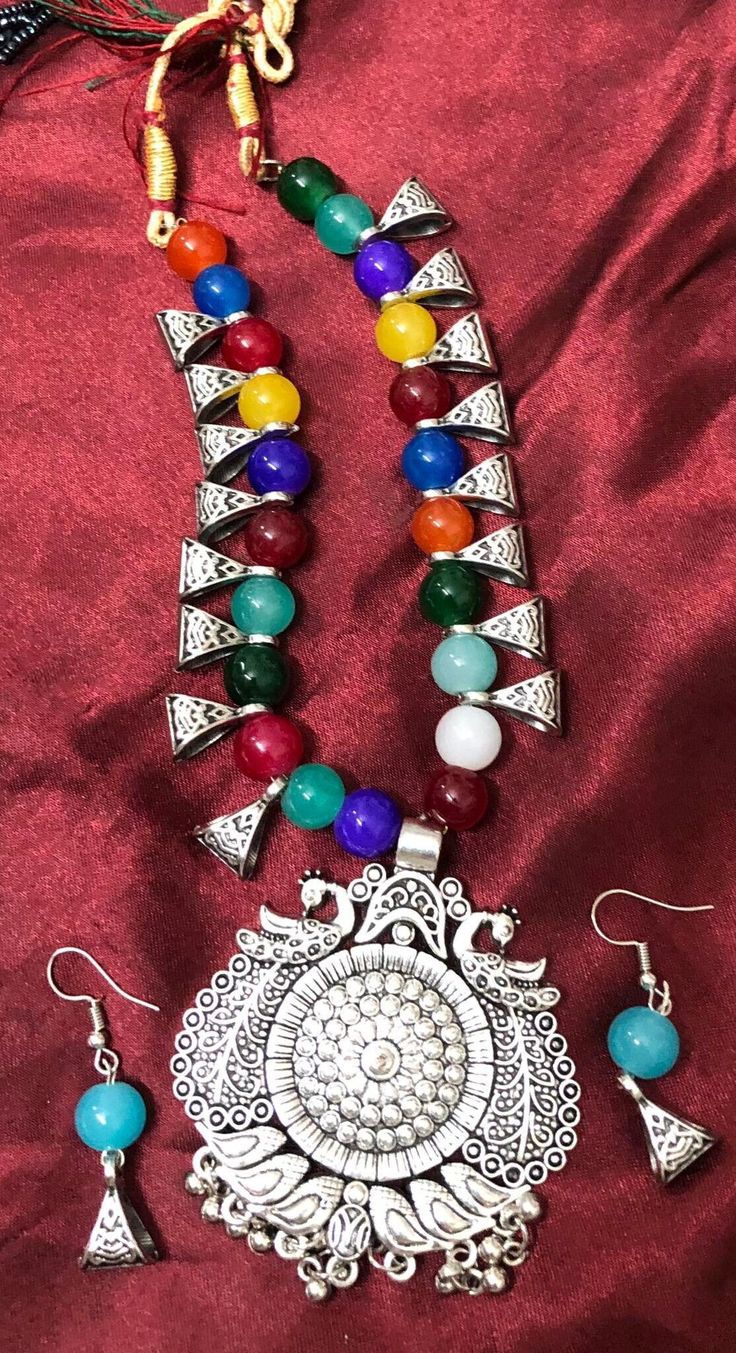 This style of Choker and Earrings set is a traditional and iconic style of jewelry that originated from India and is popular throughout the Indian subcontinent. This set is known for it's distinctive design. This type of jewelry is a significant part of Indian culture and is worn by women on various occasions, including weddings, festivals, and other celebrations. The choker necklace has a detailed design in the pendant and colorful beads in necklace make this a beatiful set to treasure.  Versatility: This set commonly worn with traditional Indian attire such as sarees and lehengas, they can also be paired with contemporary outfits to add a touch of elegance and ethnicity to one's look. Size: Adjustable necklace Color & Design:  Multi color Note: earrings are for pierced ears only, the nec Multicolor Oxidized Jewelry As Gift, Multicolor Oxidized Finish Jewelry As Gift, Multicolor Temple Jewelry Pendant Set, Traditional Decorative Jewelry, Oxidized Round Beads Jewelry For Gift, Gift Jewelry With Oxidized Round Beads, Traditional Multicolor Jewelry Sets With Oxidized Finish, Traditional Multicolor Pendant Jewelry Set, Festival Pendant Jewelry With Matching Earrings