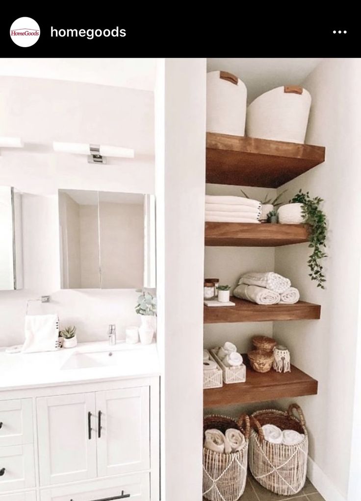 a white bathroom with open shelving and baskets