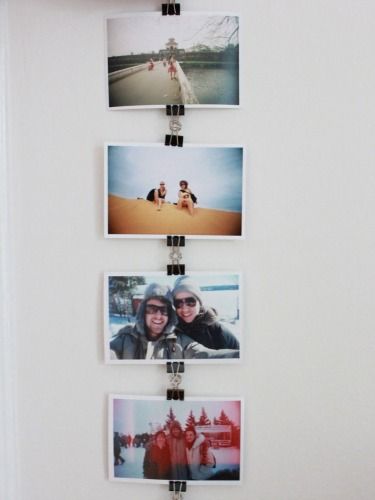 four polaroid photos hanging on a white wall