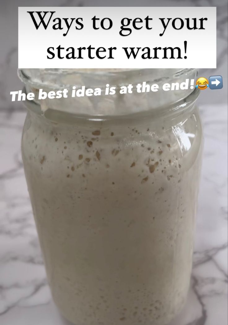 a glass jar filled with liquid sitting on top of a counter next to a sign that says, ways to get your starter warm the best idea is at the end