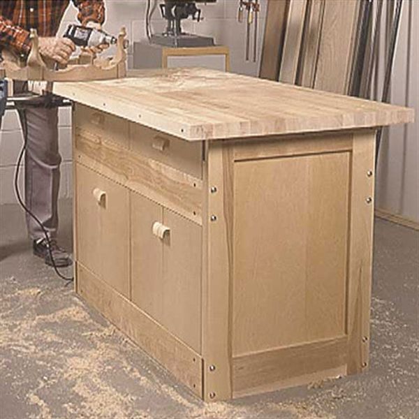 a man sanding wood on top of a workbench