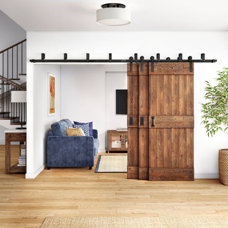 a living room filled with furniture and a wooden door leading to a loft style bedroom