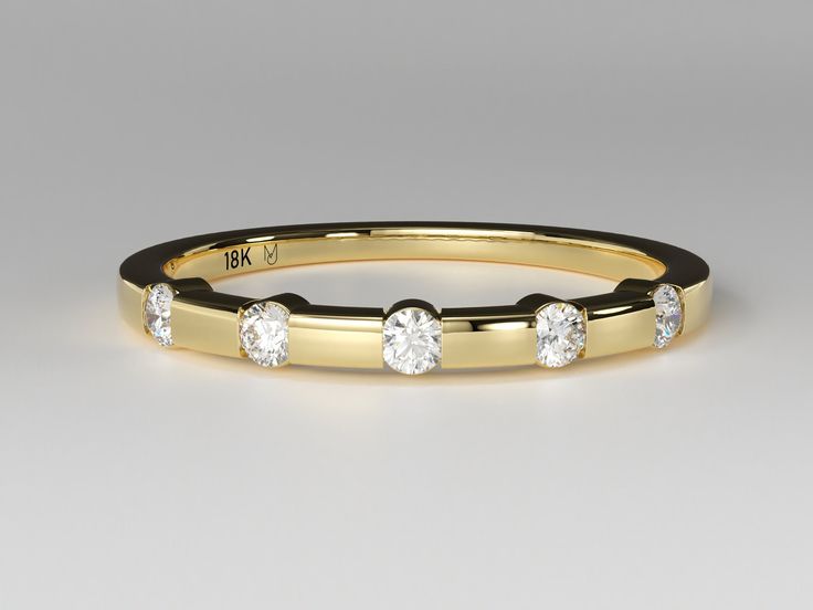 A sweet, yellow gold stackable ring featuring a single row of round brilliant cut Diamonds with matte gold spacers in between each stone.   Metal - 14K Yellow Gold Finger Sizes available - 4 to 9 (Other sizes available upon request) Gemstone (s) Type - 5 Natural Round Brilliant Cut Diamonds Size - 2.0mm Diameter  Weight - 0.15 carats Color - G-H Clarity - SI Cut - Very Good The item is handcrafted and made to order so you can ensure you'll receive a brand-new piece made just for you. Items ship within 2 - 3 weeks. If you would like to have this style customized, set with a different size stone, or made with another type of gemstone, please send us a message and we would be happy to get you a quote!  All J. Lauren Jewels purchases will be shipped in a grey velvet jewelry boxes. Ring sizing Yellow Gold Stackable Channel Set Rings, Yellow Gold Stackable Rings With Tension Setting, Yellow Gold Stackable Ring, Gold Rings Stackable, Velvet Jewelry, Types Of Gemstones, Stackable Ring, Grey Velvet, Anniversary Bands