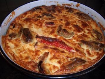 a casserole dish with meat and cheese in it