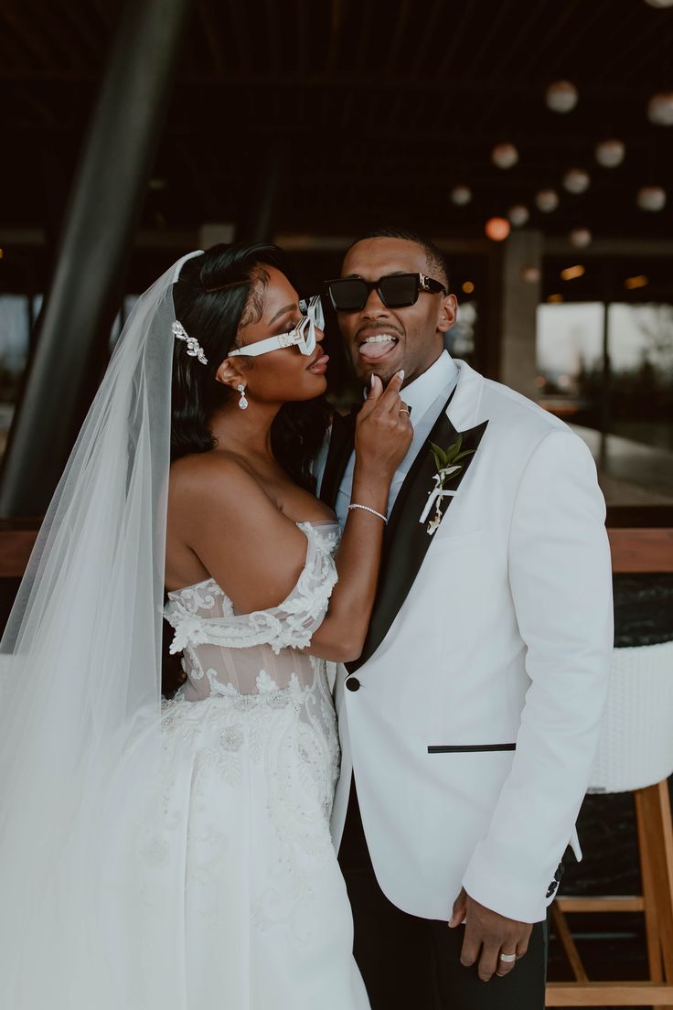 a bride and groom pose for a wedding photo