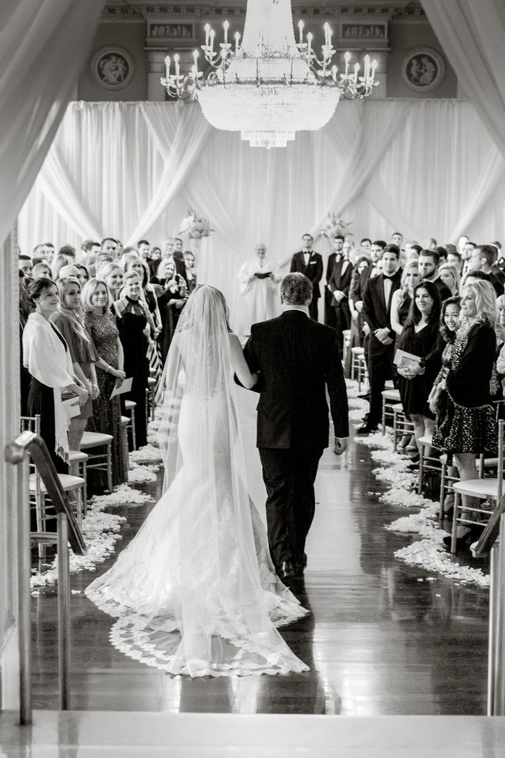 a bride and groom walking down the aisle