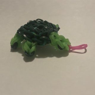 a small green and pink object sitting on top of a table