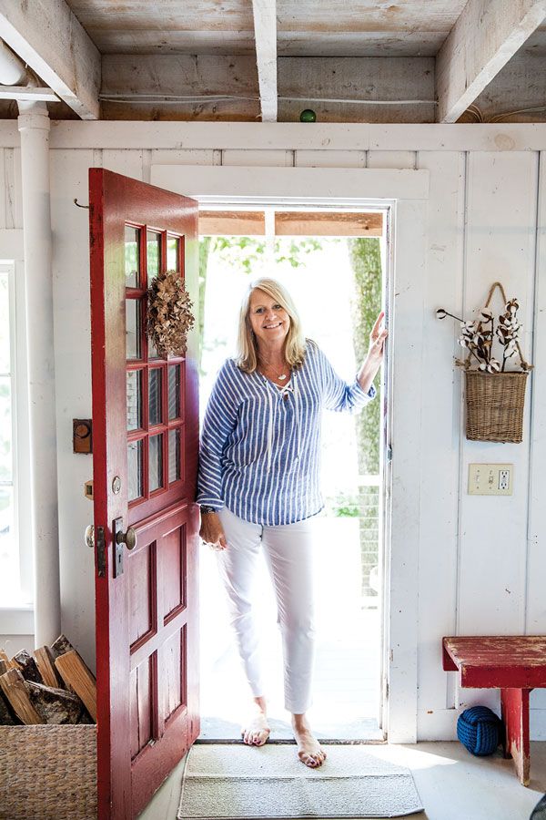 a woman standing in the doorway of a house