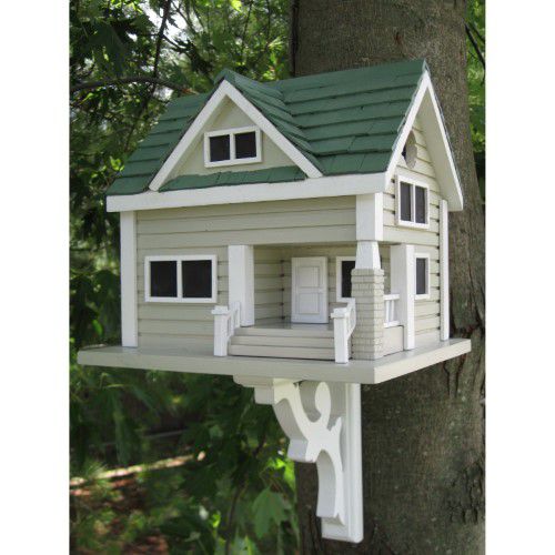 a white bird house on the side of a tree