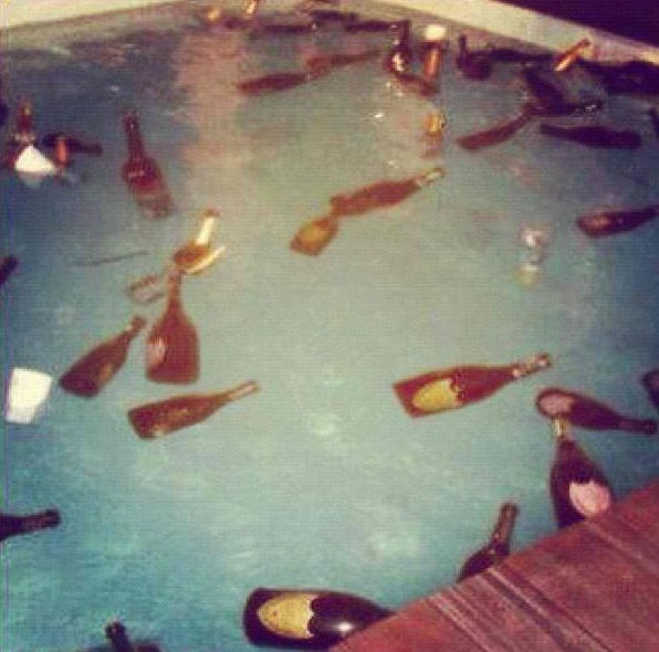 there are many bottles in the water and one is filled with people's feet