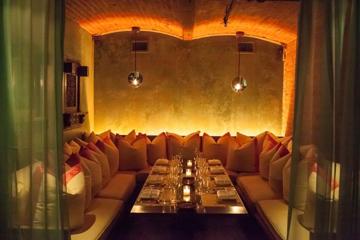 a long table is set up in the middle of a room with lights on it