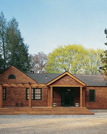 a large brown brick house sitting in the middle of a forest