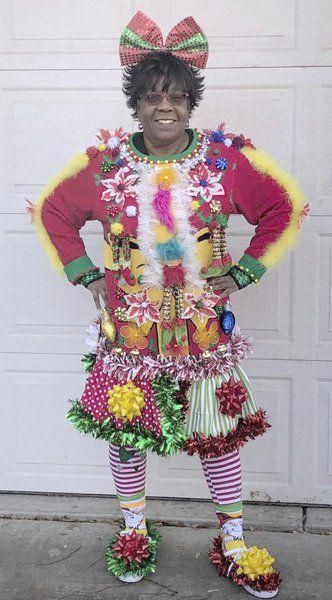 a man dressed up like a clown standing in front of a garage door