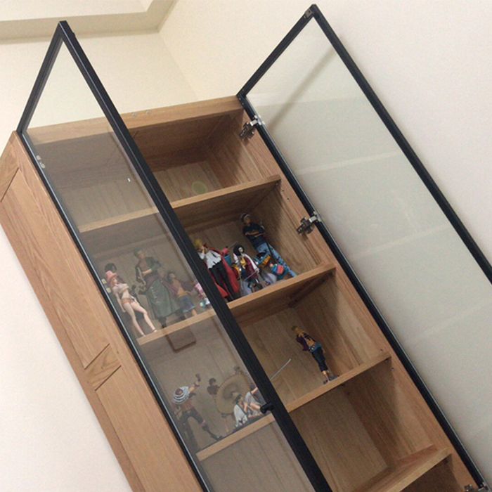 a wooden shelf with glass doors and shelves filled with toy figurines