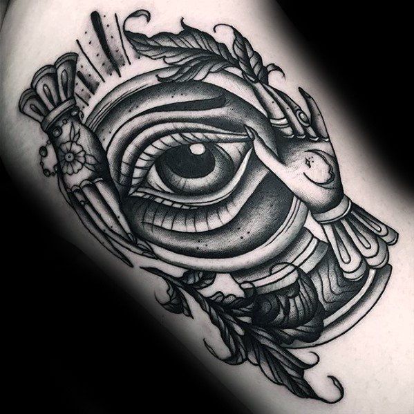 a black and white photo of an all seeing eye tattoo on the right thigh by cheydry