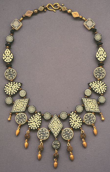 an elaborate necklace with gold and black beads