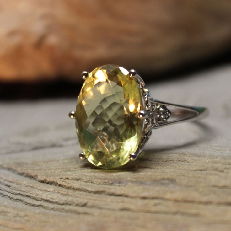 Stunning 2000 Vintage 14k Solid Gold 12.5 ctw Large Topaz Ring 5.3 Grams Size 7.5 Solid Gold Topaz Ring Vintage Gold Ring Vintage Gold Topaz Ring *Last photo* There is an appraisal for the ring which was done in 2007 & valued then at $499  Beautiful single large lemon topaz stone 12.5ctw & 2 diamonds set in 14k solid white gold.  2000 The large lemon topaz stone is 12.48ctw & measures 1/2" x 3/4" and is beautiful. The stone sits 1/2" above the finger There are 2 diamonds, one each side & are app Formal Yellow Topaz Ring With Diamond Accents, Exquisite Gemstone Topaz Ring For Anniversary, Exquisite Topaz Gemstone Ring For Anniversary, Elegant Green Oval Topaz Ring, Classic Topaz Gemstone Rings, Oval Topaz Gemstones With Prong Setting, Formal Citrine Birthstone Ring In Fine Jewelry Style, Formal Topaz Ring With Gemstone Accents, Formal Fine Jewelry Citrine Birthstone Ring