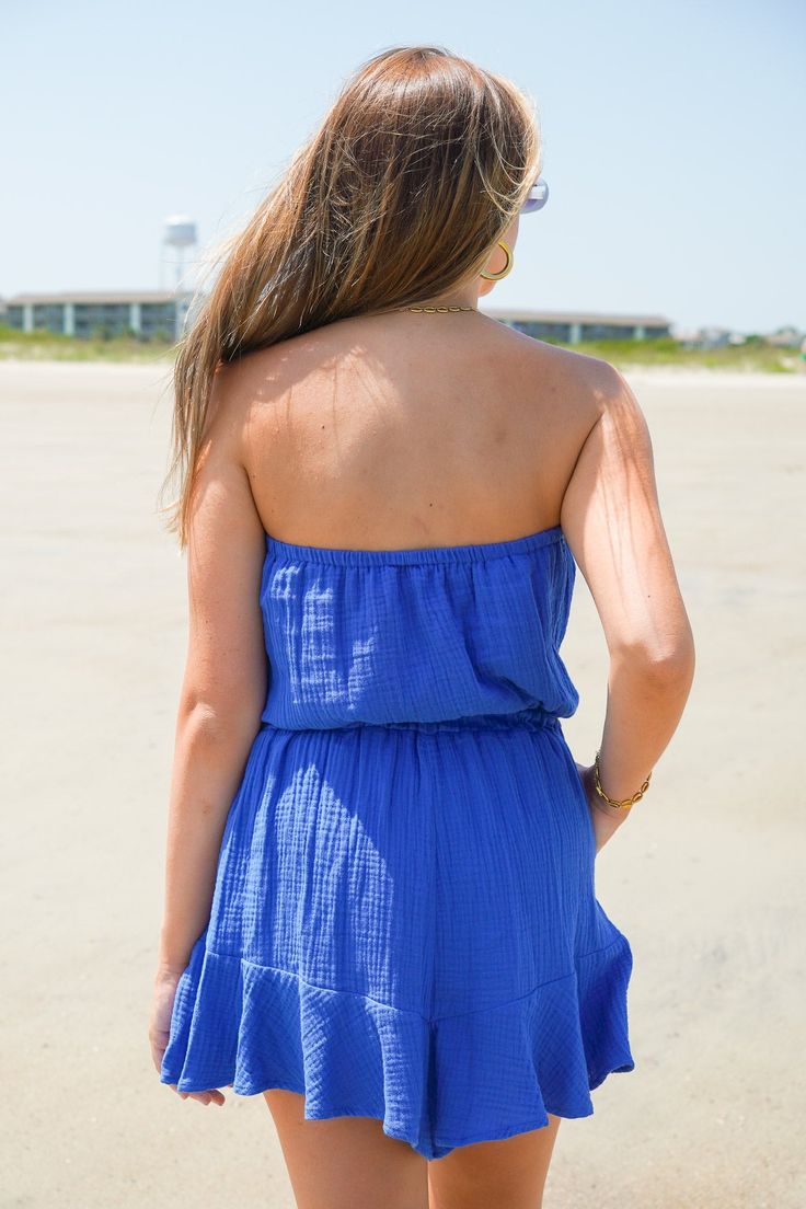 Our Crystal Sands Romper is the perfect outfit to throw on during those warm summer days! Made with gauze material, this royal blue strapless romper features an elasticized neckline and waistband with a faux drawstring tie for effortless style and comfort. Complete with two side pockets and a playful ruffle detail at the hem, this romper is the perfect outfit on the go. Just add sandals, sunglasses, and your favorite jewelry for the ultimate look! It is lightweight, not lined, and fits true to s Strapless Romper, New Arrival Dress, Top Dress, Perfect Outfit, Summer Days, Savannah Chat, Effortless Style, Favorite Jewelry, Royal Blue