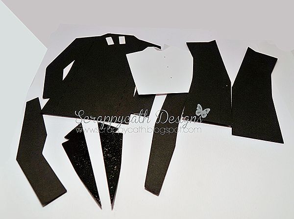 cut out pieces of black paper sitting on top of a table