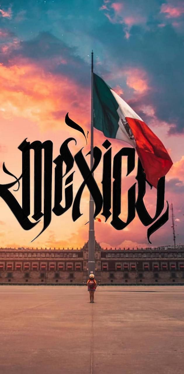 a man standing in front of a flag with the word mexico on it's side