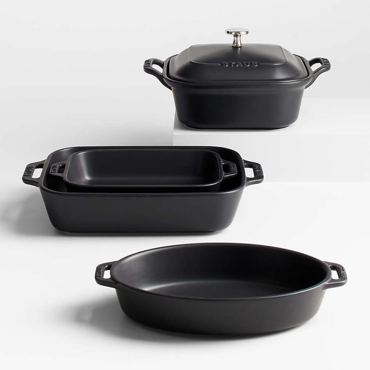 three black cast iron casserole dishes