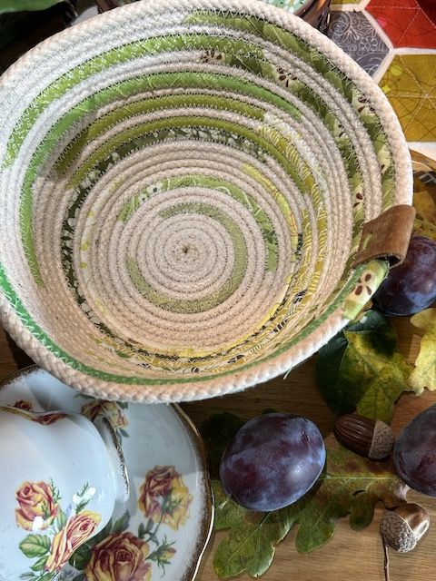 an assortment of fruit and vegetables are arranged in baskets on a table with other items