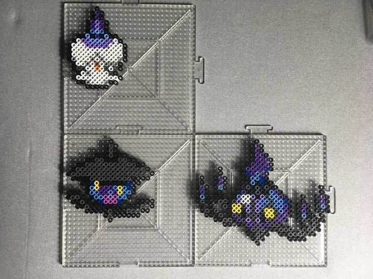 two pieces of bead art on a white surface with black and blue beads in the shape of cats