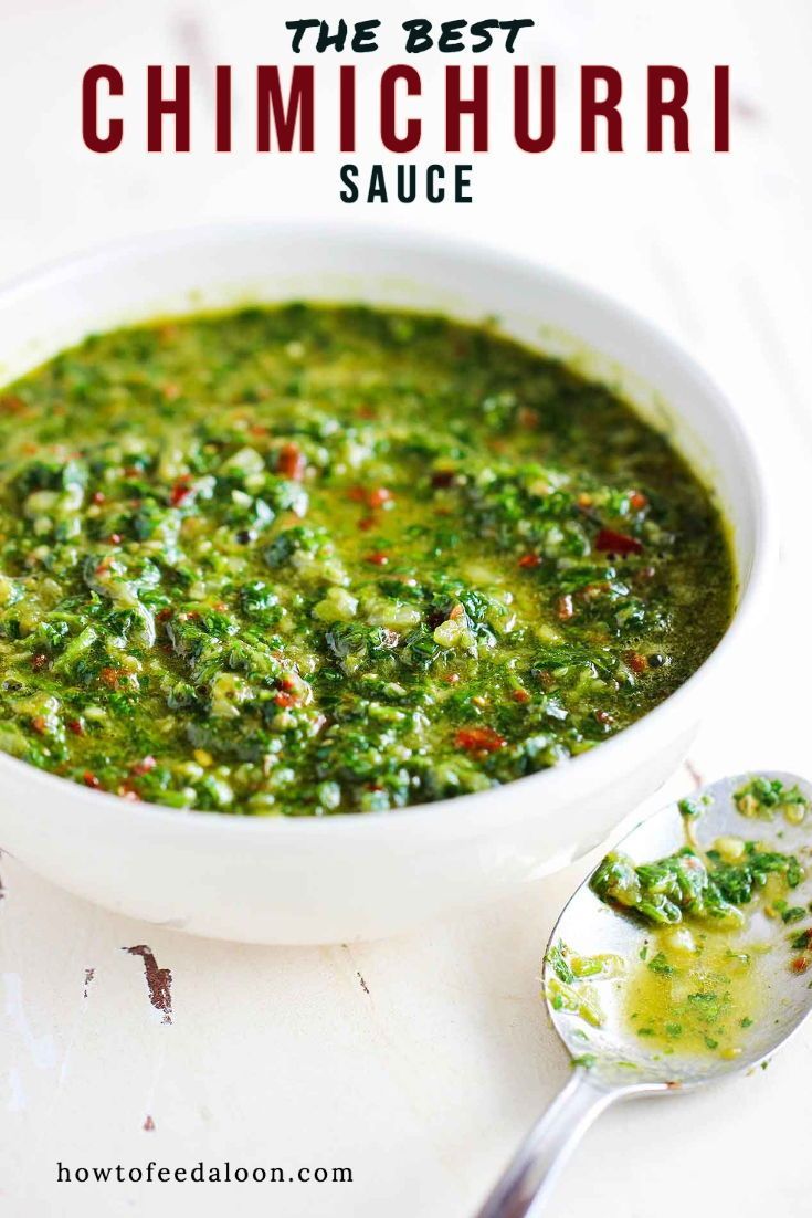 a white bowl filled with green soup next to a spoon