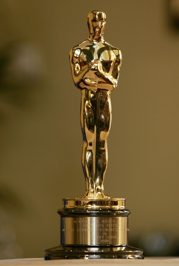 an oscar statue sitting on top of a table