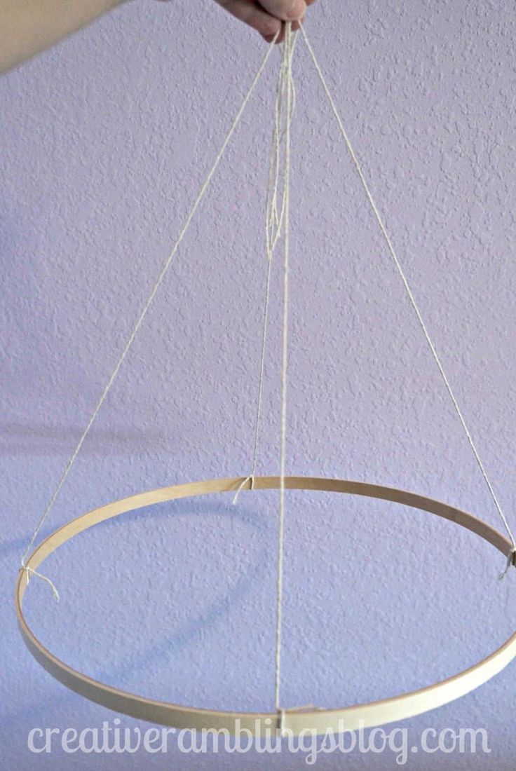 a person is holding an object in the air with two strings hanging from it's sides