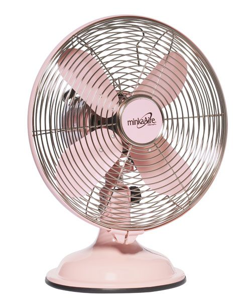 a pink fan sitting on top of a table