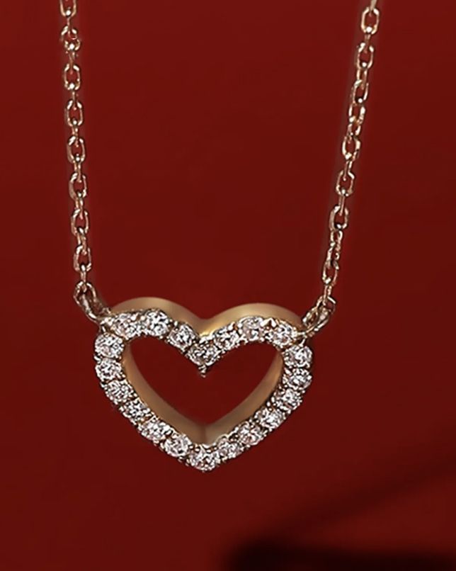 Add a touch of elegance to your wardrobe with our exquisite 14k gold Tiny Diamond Heart Necklace. This stunning piece features a delicate heart pendant adorned with 18 sparkling diamonds. Perfect for any occasion, the fine gold chain and pendant create a timeless accessory. Treat yourself or a loved one to the allure and sophistication of this brilliant treasure. Gold Diamond Heart Pendant Necklace, Rose Gold Diamond Heart Necklace With Charm, Gold Heart Pendant Diamond Necklace For Valentine's Day, Heart-shaped Diamond Necklace With Heart Charm For Valentine's Day, Gold-tone Heart Pendant Necklace For Valentine's Day, Heart Necklace Diamond, Gold Chain With Pendant, Meaningful Jewelry, 14k Gold Necklace