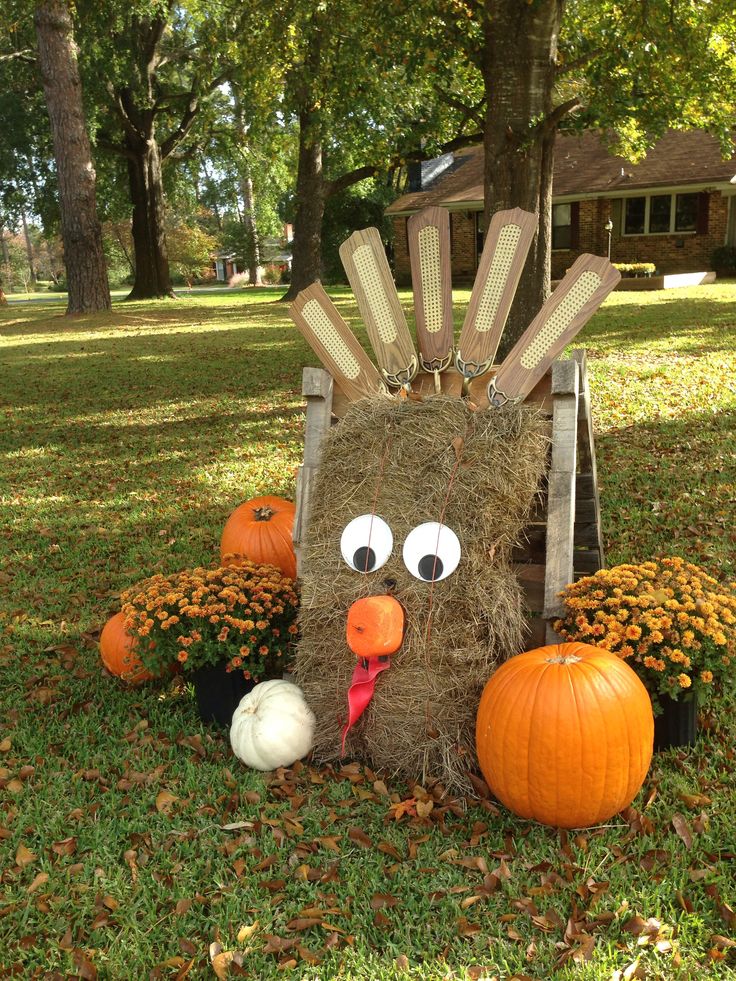 a scarecrow made out of hay and pumpkins