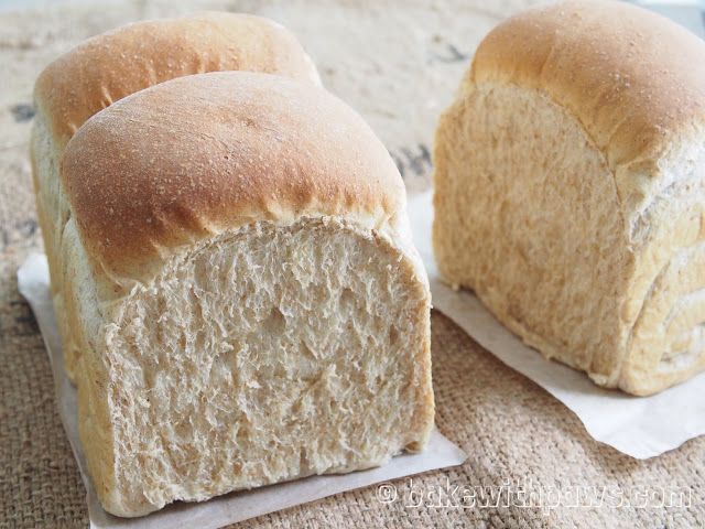 two loaves of bread sitting on top of a table next to some paper towels