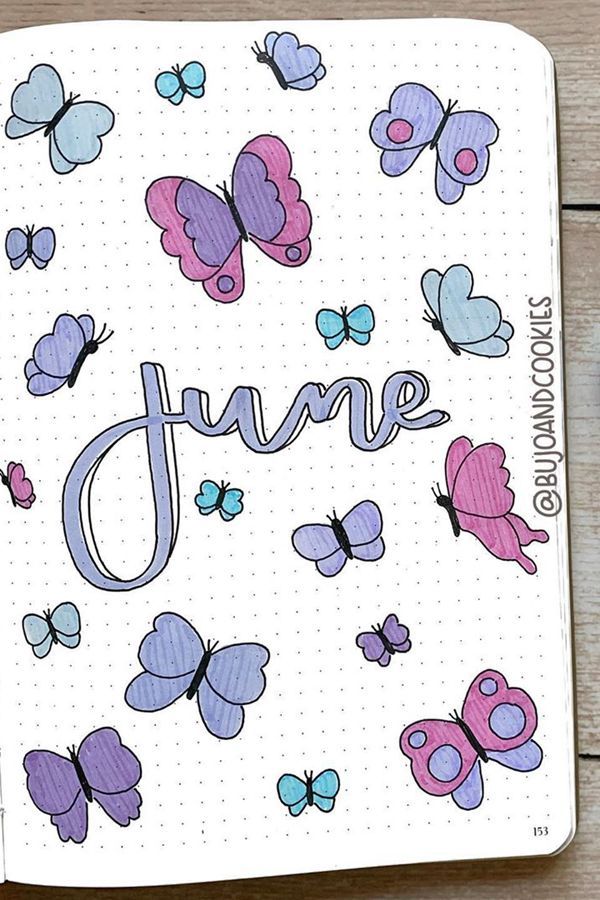 a notebook with butterflies and the word june written in blue, pink, and purple