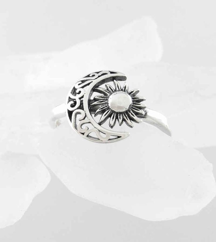 Material: 100% Sterling silver Weight: 2.1 grams Crescent and flower together are 1/2 inch wide x more than 3/8 inch tall (12 x 11mm) Band is more than 1/16 inch wide (2mm) Item number: wh295 The vine-like scrollwork of the crescent moon and the petal-like rays of the sun give this celestial ring an earthy character. The sun is also oxidized for an aged effect and the crescent is cut-out to make the scrollwork more lacey. Adjustable Crescent Silver Jewelry, Silver Jewelry With Sun And Moon Design, Vintage Sun And Moon Design Ring, Vintage Sun And Moon Ring, Silver Crescent Filigree Jewelry, Symbolic Silver Jewelry With Sun And Moon Design, Bohemian Silver Moon Charm Ring, Spiritual Silver Crescent Rings, Bohemian Silver Ring With Moon Charm