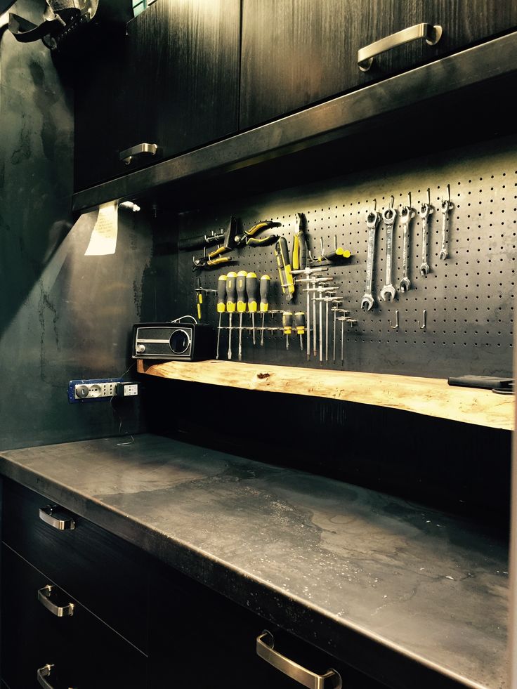 a tool cabinet with tools hanging on the wall