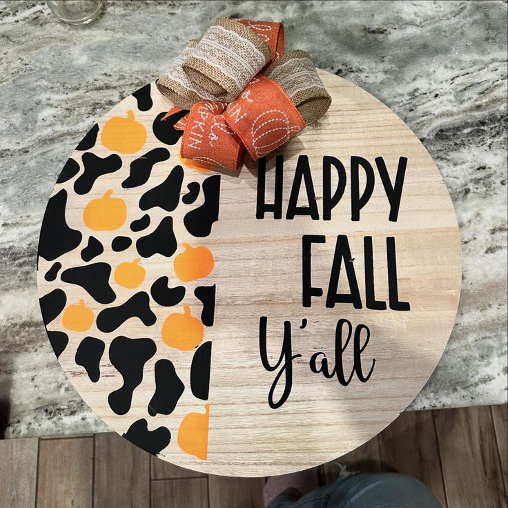 a wooden sign that says happy fall y'all with an orange bow on it